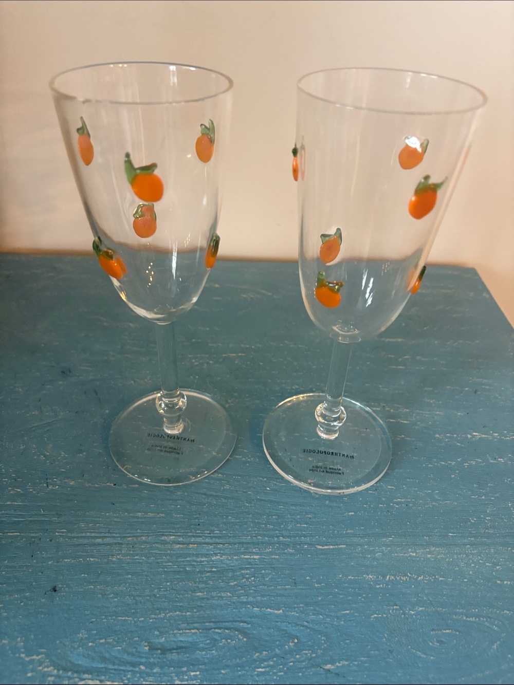Anthropologie Clear Wine Glasses with Orange Fruit Accents
